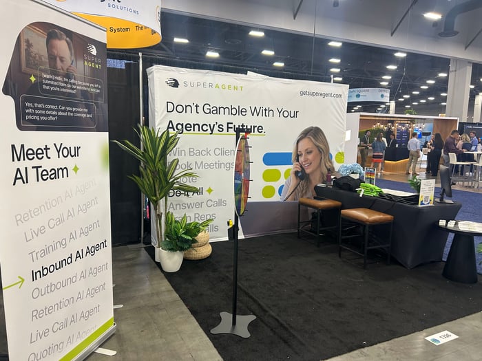 The SUPERAGENT booth at ITC Vegas 2026 with the Meet Your AI Team banner